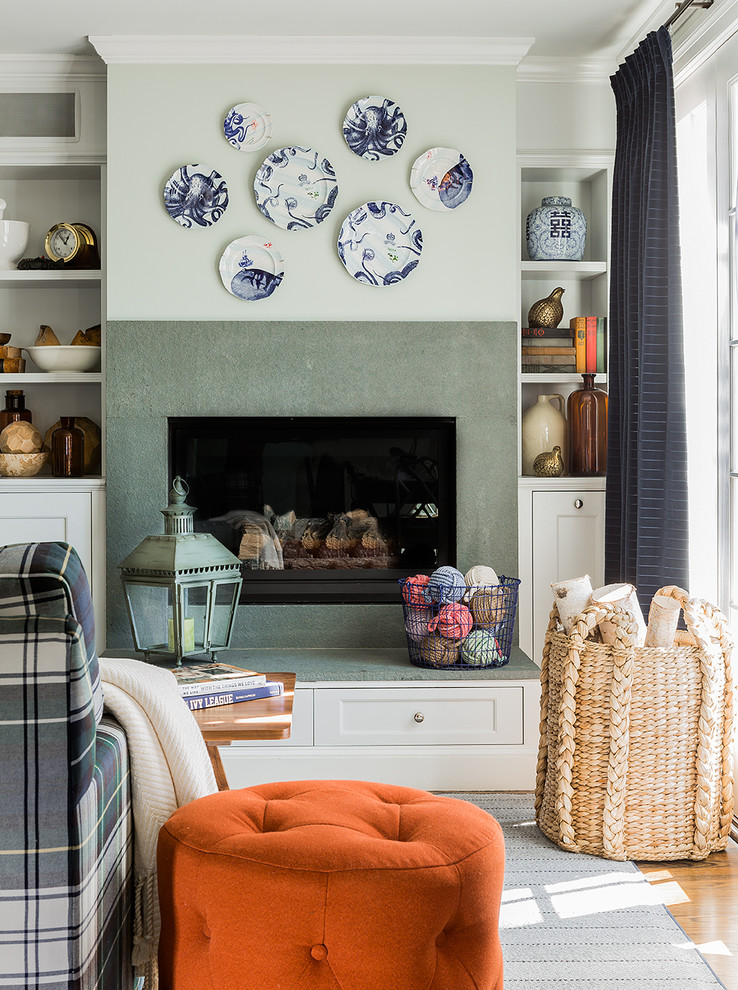 This is an example of a contemporary living room in Boston with green walls and a standard fireplace.