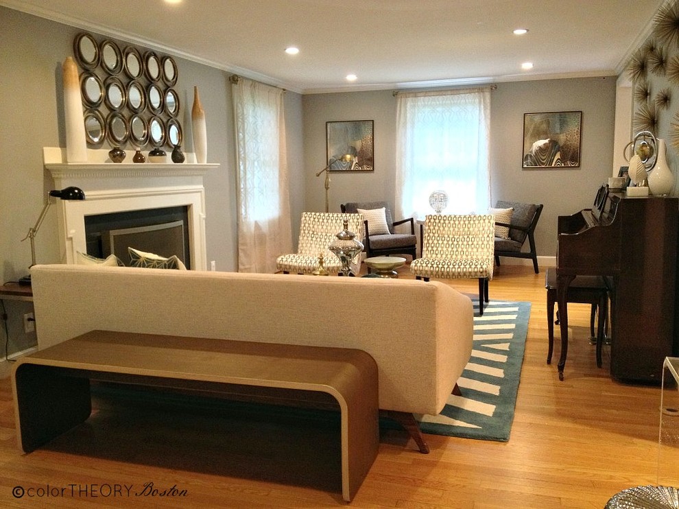 Example of a large trendy formal and enclosed light wood floor living room design in Boston with gray walls, a standard fireplace, a wood fireplace surround and no tv