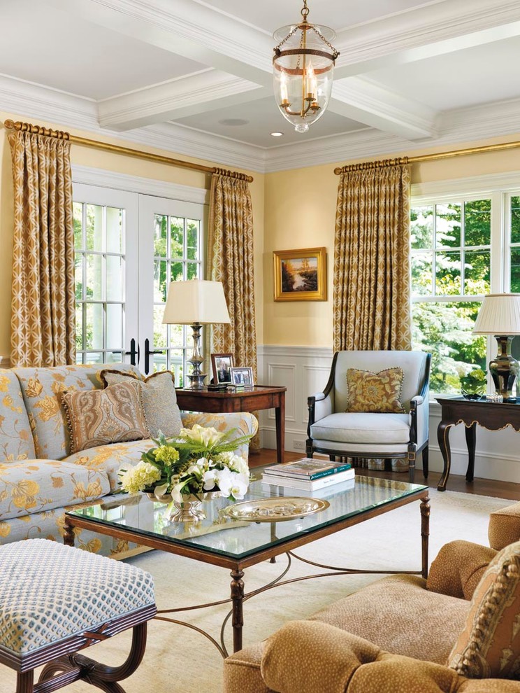 This is an example of a large traditional formal enclosed living room in Boston with yellow walls, medium hardwood flooring, no fireplace, no tv and brown floors.