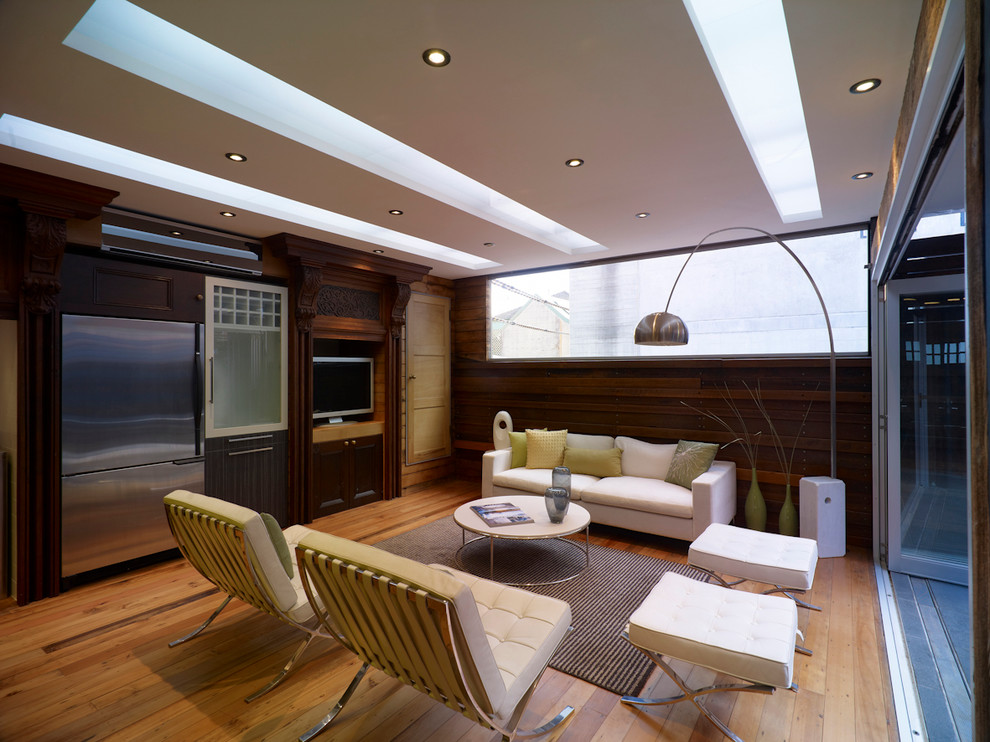 Mittelgroßes, Offenes Modernes Wohnzimmer ohne Kamin mit hellem Holzboden, freistehendem TV und beigem Boden in Sydney