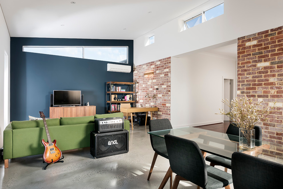 Foto på ett mellanstort funkis allrum med öppen planlösning, med betonggolv, ett musikrum, blå väggar och en fristående TV