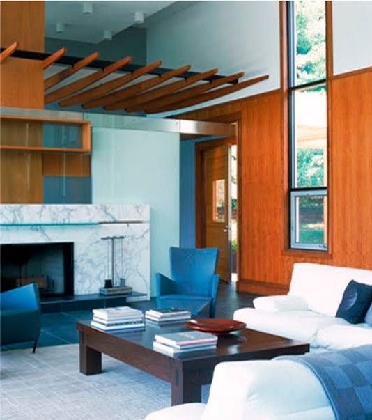 Cette image montre un grand salon design ouvert avec une salle de réception, un mur marron, un sol en ardoise, une cheminée standard, un manteau de cheminée en pierre, aucun téléviseur et un sol bleu.