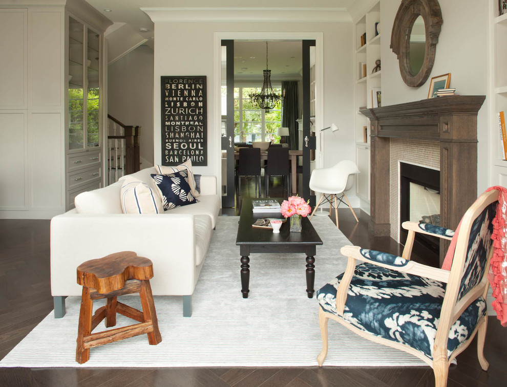 Example of a trendy dark wood floor living room design in Vancouver with beige walls, a standard fireplace, a tile fireplace and no tv