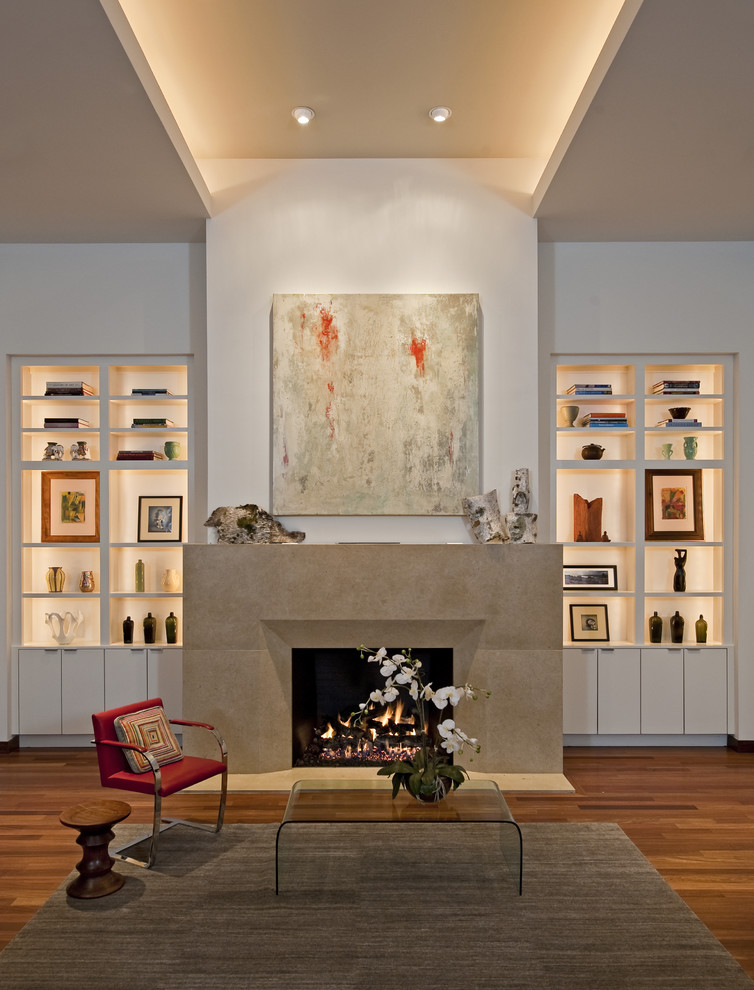 This is an example of a contemporary living room in Austin with white walls, a standard fireplace and feature lighting.