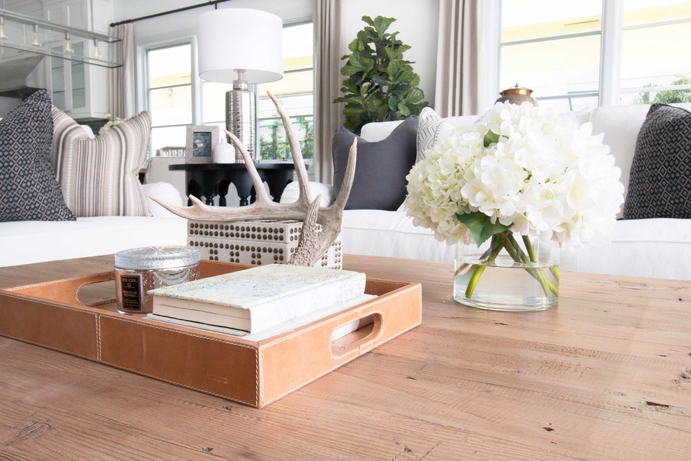 Living room - coastal medium tone wood floor living room idea in Orange County with white walls