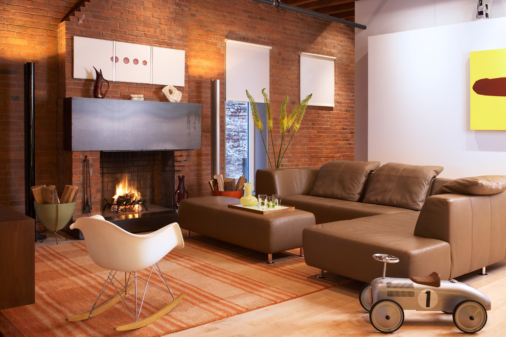 Example of a mid-sized urban light wood floor living room design in New York with white walls, a standard fireplace and a brick fireplace