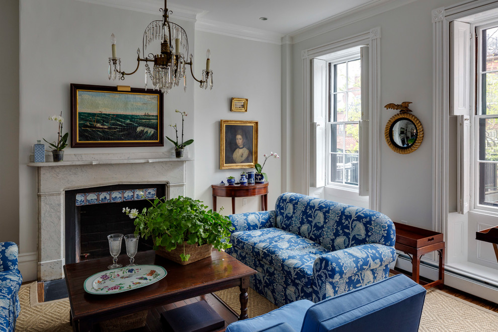 Example of a mid-sized classic formal and enclosed medium tone wood floor living room design in Boston with white walls, a standard fireplace and a stone fireplace