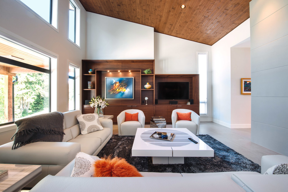 Immagine di un grande soggiorno design aperto con pareti bianche, pavimento in gres porcellanato, parete attrezzata e pavimento beige