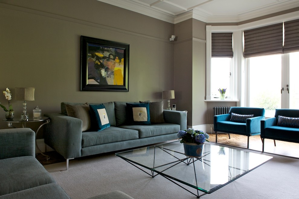 This is an example of an eclectic grey and teal living room in London.