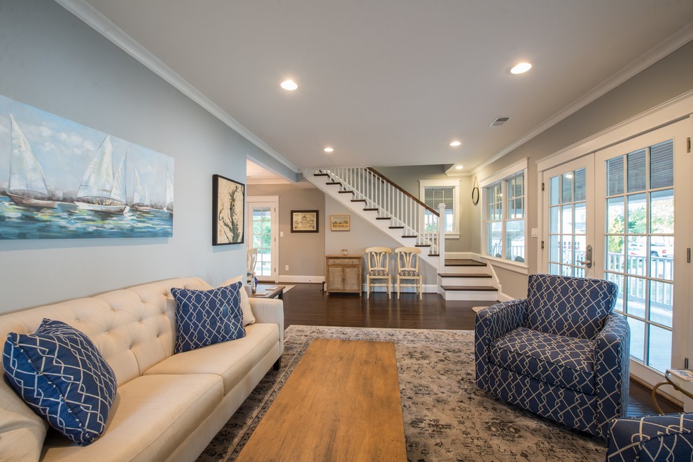 Inspiration for a medium sized nautical open plan living room in DC Metro with grey walls, dark hardwood flooring, a standard fireplace, a brick fireplace surround and a wall mounted tv.