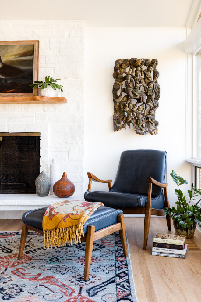 Design ideas for an eclectic living room in Seattle with white walls and a stone fireplace surround.