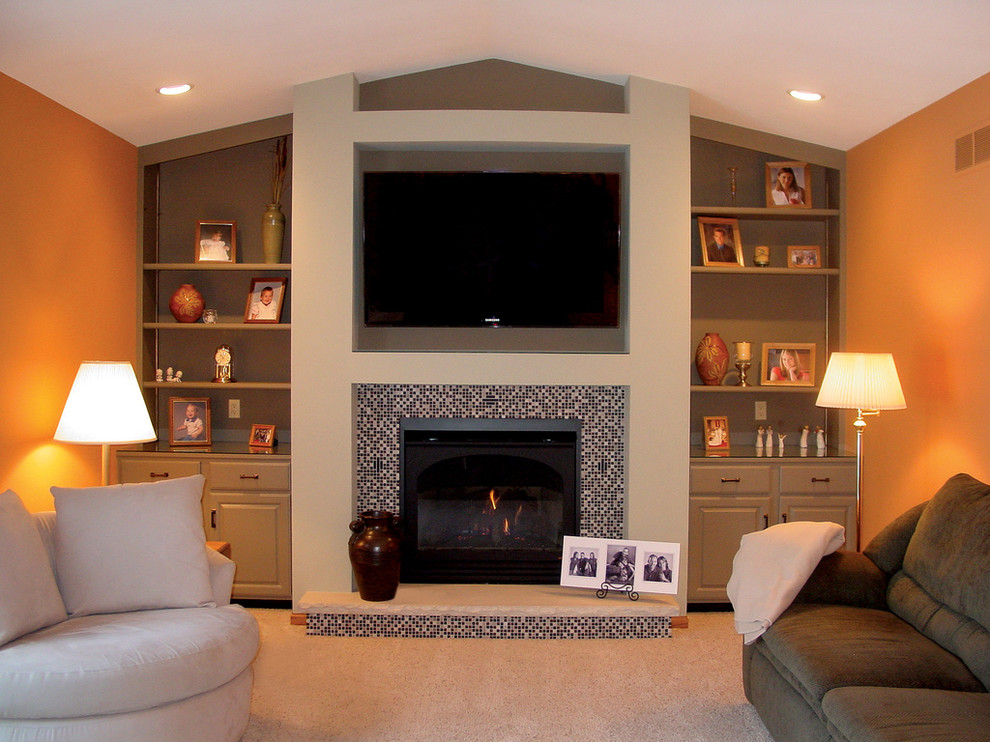 Photo of a medium sized classic living room in Other with orange walls, carpet, a standard fireplace, a tiled fireplace surround and a wall mounted tv.