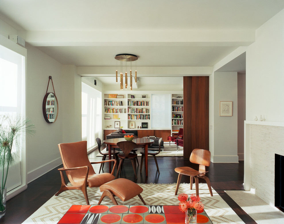 This is an example of a contemporary open plan living room in New York with dark hardwood flooring.