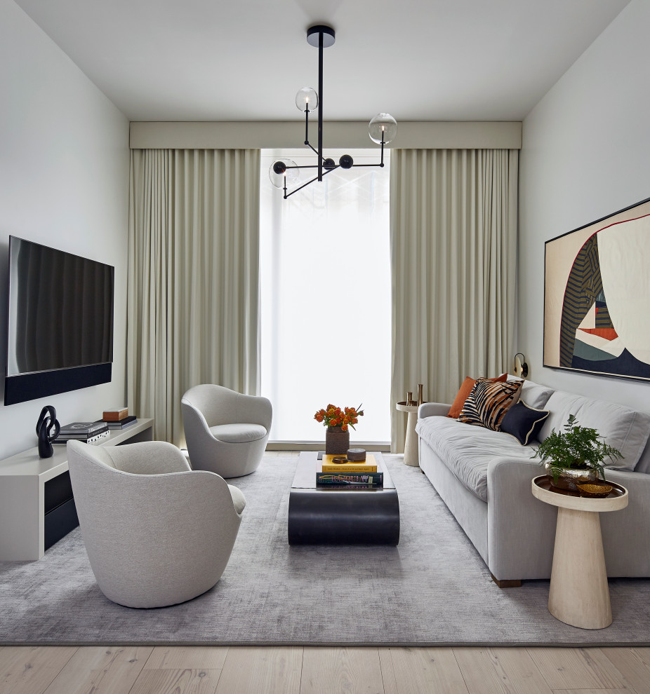 Inspiration for a medium sized contemporary open plan living room in New York with white walls, light hardwood flooring, no fireplace, a wall mounted tv and beige floors.