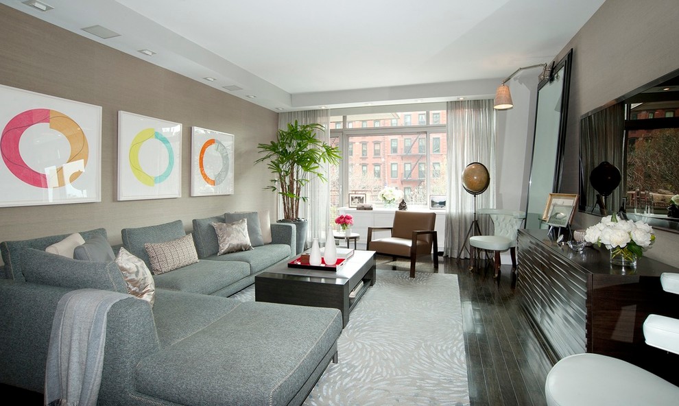Example of a large trendy open concept dark wood floor living room design in New York with beige walls and a wall-mounted tv
