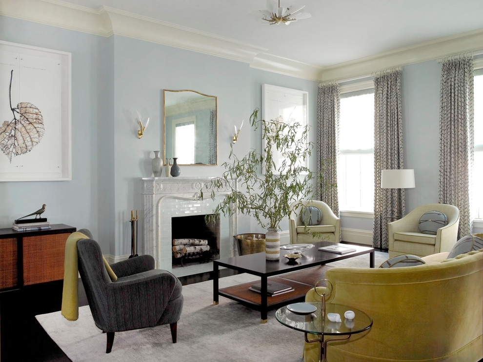 На фото: парадная гостиная комната в классическом стиле с синими стенами, стандартным камином и красивыми шторами