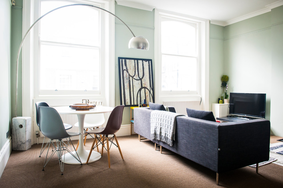Свежая идея для дизайна: парадная гостиная комната в стиле модернизм с отдельно стоящим телевизором, зелеными стенами, ковровым покрытием и синим диваном - отличное фото интерьера