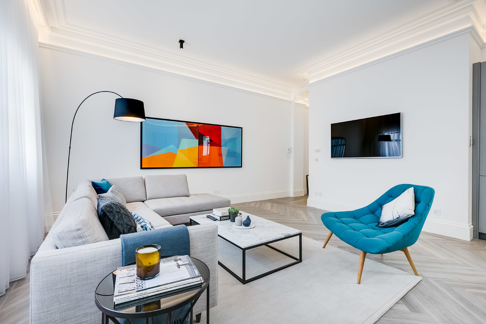 Foto på ett minimalistiskt separat vardagsrum, med vita väggar, ljust trägolv, en väggmonterad TV och grått golv