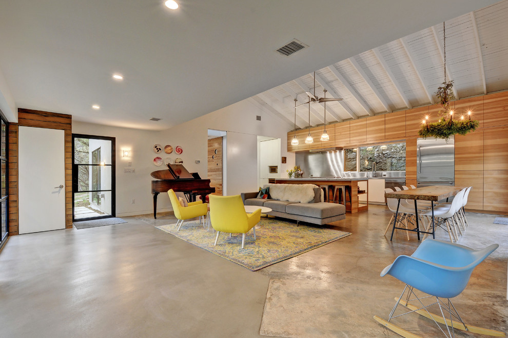 Inspiration for a large eclectic open concept concrete floor and gray floor living room remodel in Austin with a music area, white walls and no fireplace