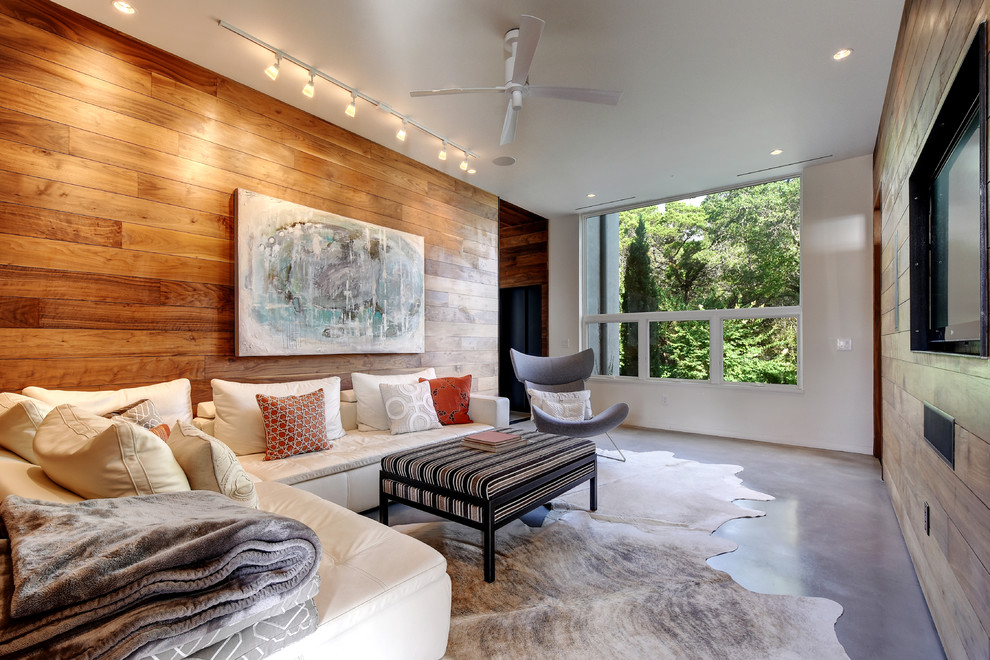 Repräsentatives Modernes Wohnzimmer mit brauner Wandfarbe, Betonboden und Multimediawand in Austin