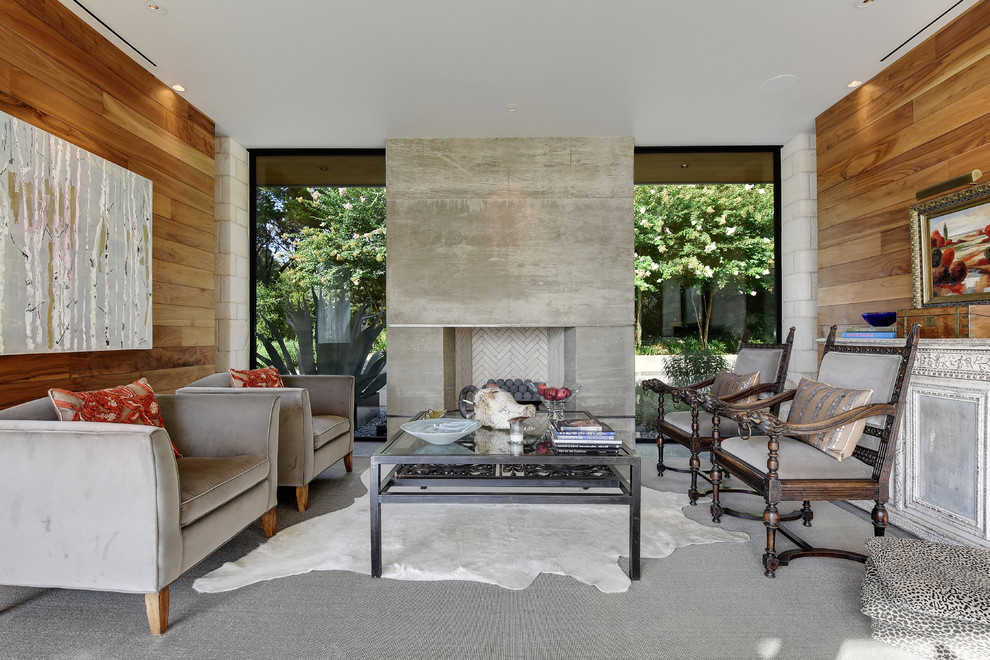 This is an example of a contemporary formal living room in Austin with brown walls, carpet, a standard fireplace and a concrete fireplace surround.