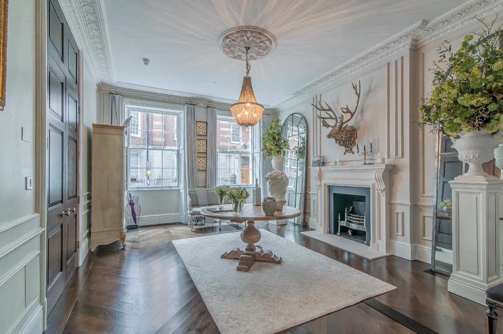 Photo of an expansive classic formal open plan living room in London with beige walls, dark hardwood flooring, a standard fireplace, a stone fireplace surround and no tv.