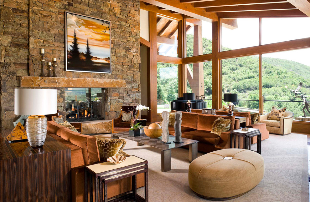 Large rustic open plan living room in Denver with beige walls, medium hardwood flooring, a standard fireplace and a stone fireplace surround.