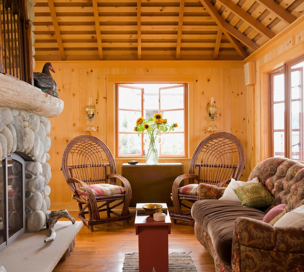 Exemple d'un petit salon montagne avec un mur marron, un sol en bois brun, une cheminée standard et un manteau de cheminée en pierre.