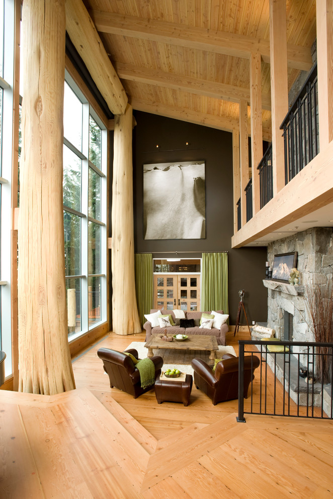 Living room - eclectic living room idea in Vancouver with black walls, a standard fireplace and a stone fireplace