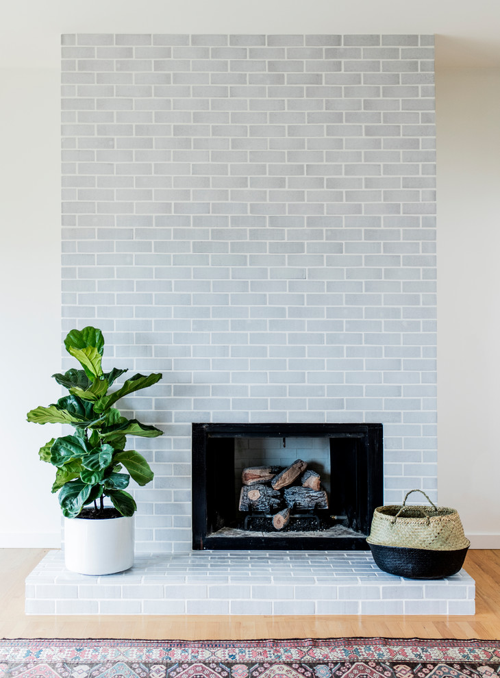 Inspiration for a midcentury living room in San Francisco with a standard fireplace and a brick fireplace surround.