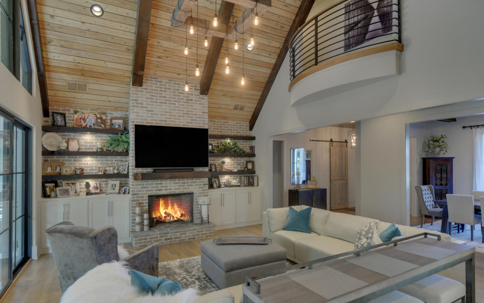 Inspiration for a large open concept medium tone wood floor and brown floor living room remodel in Atlanta with a standard fireplace and a brick fireplace