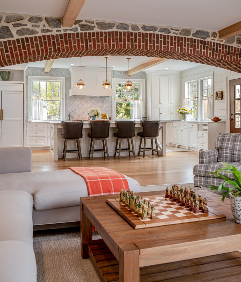 Design ideas for a large farmhouse open plan living room in Philadelphia with beige floors, white walls and medium hardwood flooring.
