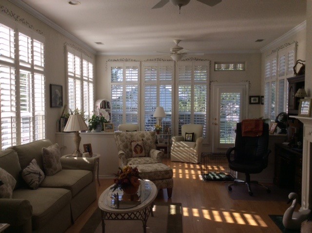 Photo of a medium sized traditional enclosed living room in New York with beige walls, medium hardwood flooring, a standard fireplace and no tv.
