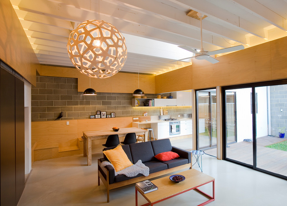 Источник вдохновения для домашнего уюта: открытая гостиная комната среднего размера в современном стиле с бетонным полом и серым полом