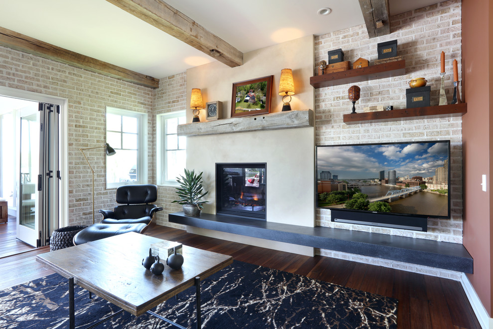 На фото: открытая гостиная комната среднего размера в стиле лофт с паркетным полом среднего тона, стандартным камином, фасадом камина из бетона и телевизором на стене с