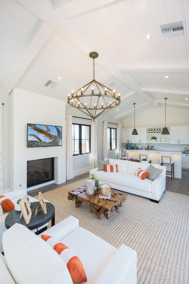 This is an example of a large traditional open plan living room in Phoenix with white walls, dark hardwood flooring and brown floors.