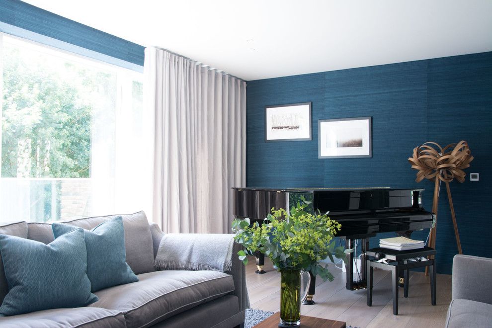 Inspiration for a large modern formal enclosed living room in Cambridgeshire with blue walls, laminate floors, no fireplace, a wall mounted tv and brown floors.