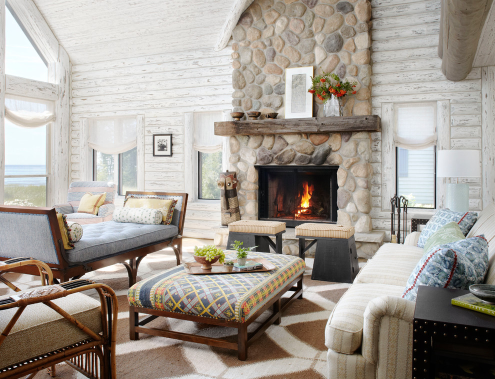 This is an example of a rustic living room in Milwaukee with a standard fireplace and a stone fireplace surround.