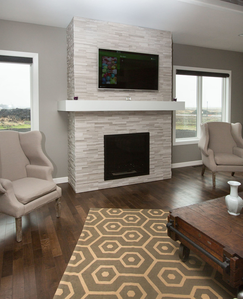 This is an example of a medium sized classic enclosed living room in Other with beige walls, medium hardwood flooring, a standard fireplace, a stone fireplace surround and a wall mounted tv.