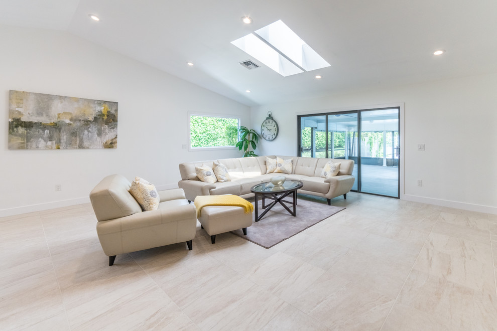 Photo of a medium sized traditional open plan living room in Miami with white walls and porcelain flooring.