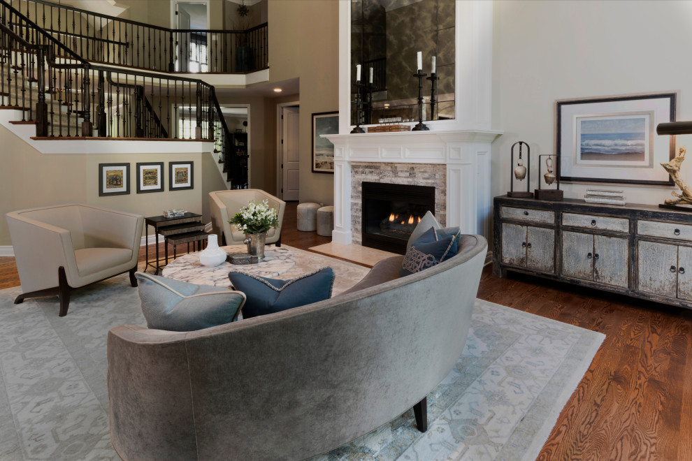 Large traditional open plan living room in Detroit with beige walls, medium hardwood flooring, a standard fireplace, a stone fireplace surround and brown floors.