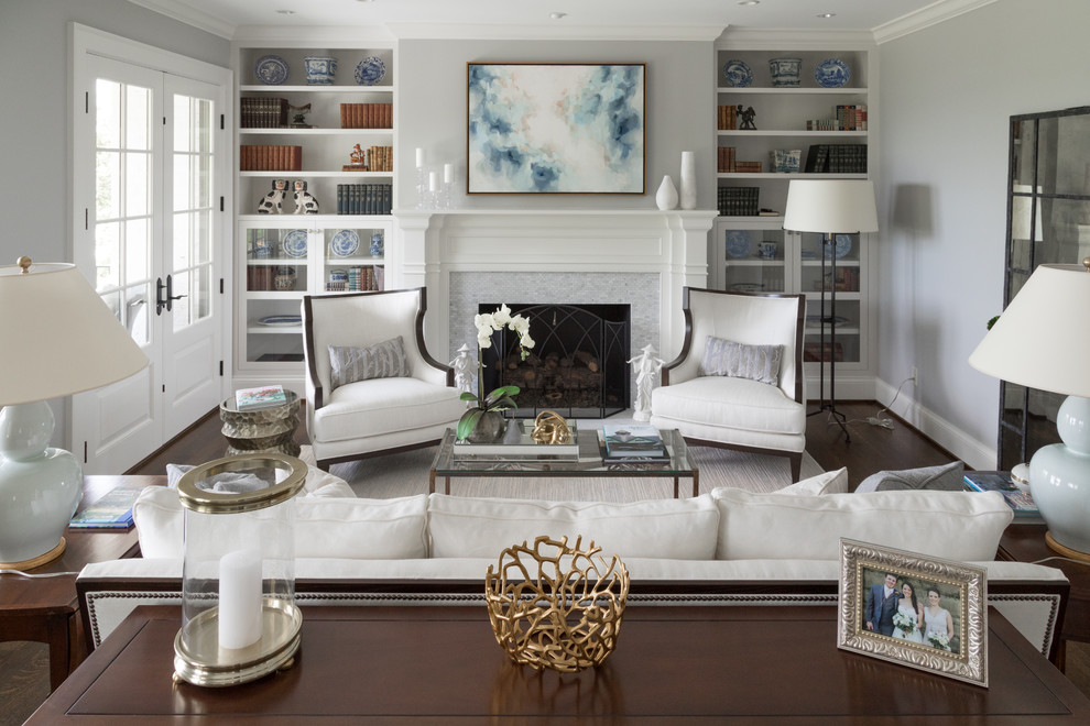 Пример оригинального дизайна: парадная гостиная комната в классическом стиле с серыми стенами, темным паркетным полом, стандартным камином, фасадом камина из плитки и коричневым полом