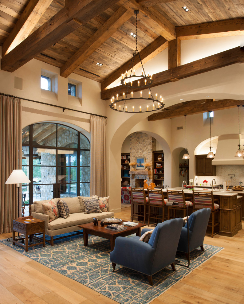 Inspiration for a southwestern medium tone wood floor and brown floor living room remodel in Phoenix with beige walls