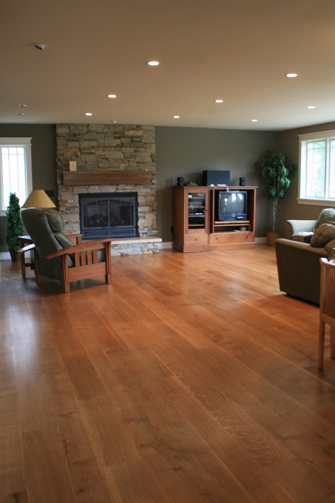 Inspiration for a mid-sized transitional formal and enclosed medium tone wood floor and brown floor living room remodel in Denver with gray walls, a standard fireplace, a stone fireplace and no tv