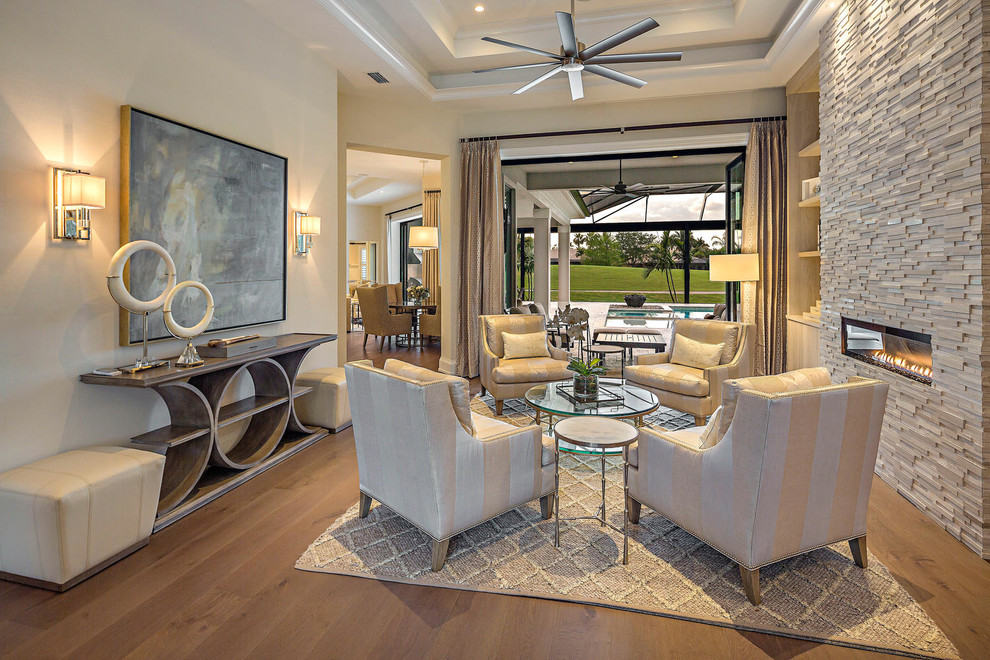 Example of a transitional light wood floor and brown floor living room design in Miami with white walls