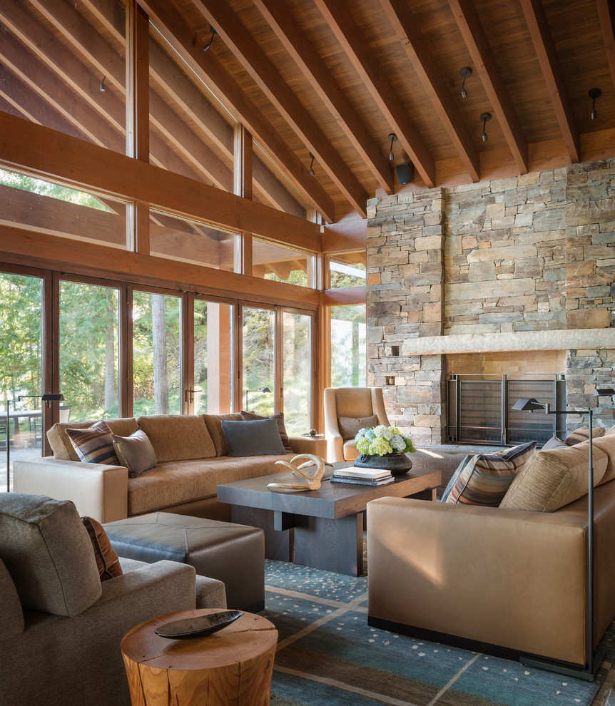 Rustic formal enclosed living room in Seattle with a standard fireplace, a stone fireplace surround and no tv.