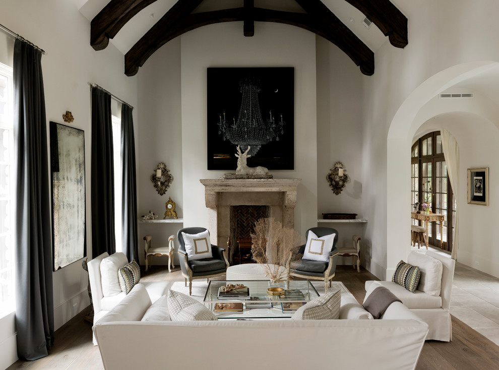 Example of a mid-sized transitional formal and enclosed medium tone wood floor and brown floor living room design in Houston with white walls, a standard fireplace, a stone fireplace and no tv
