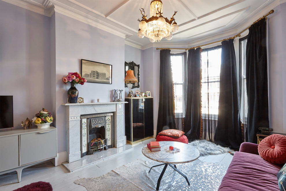 Photo of a medium sized victorian formal open plan living room in London with purple walls, painted wood flooring, a standard fireplace, a stone fireplace surround and a freestanding tv.