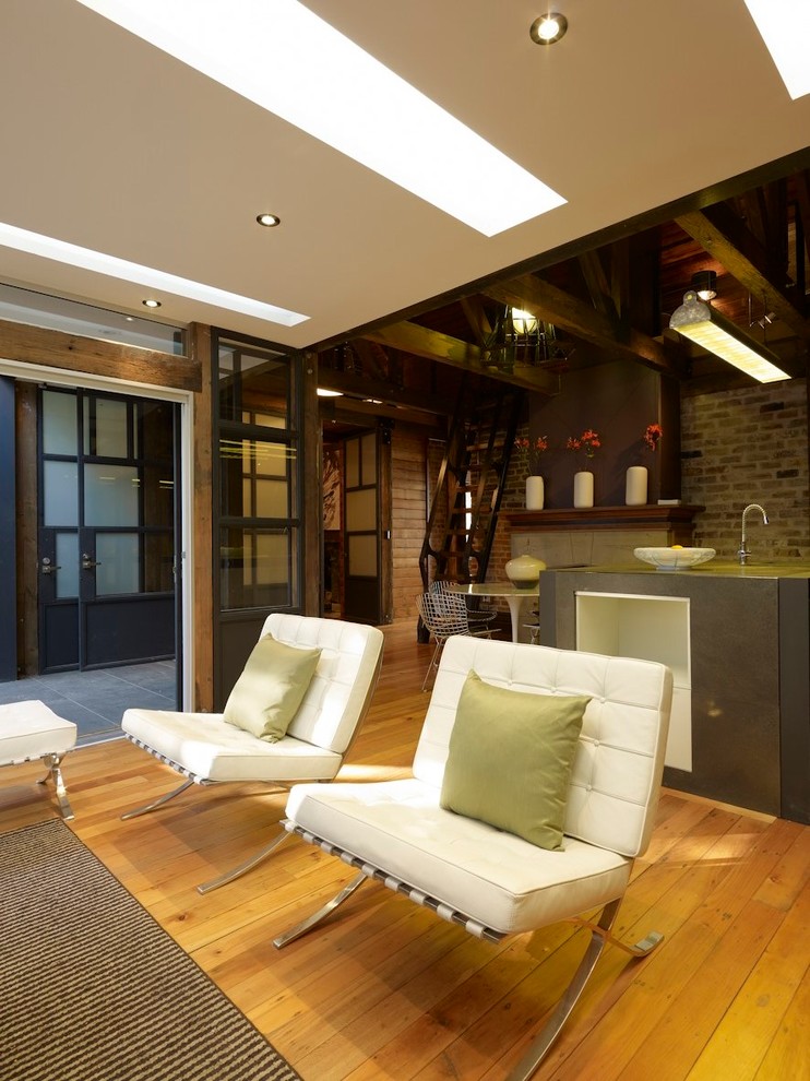 Modelo de salón para visitas abierto ecléctico de tamaño medio con suelo de madera en tonos medios y televisor independiente
