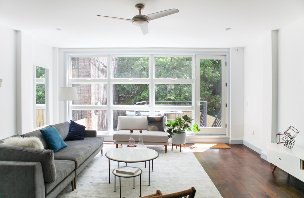 Living room - contemporary open concept medium tone wood floor and brown floor living room idea in New York with beige walls